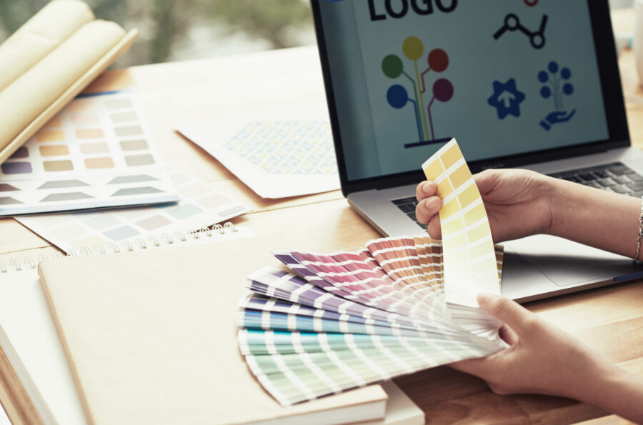 Hands of designer choosing color for her project